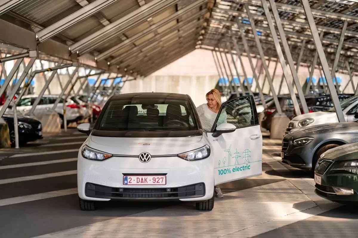 person stepping into an electric vehicle